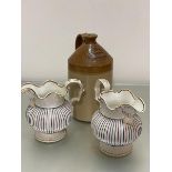 A pair of 19thc china fluted jugs decorated with C scroll handles and multicoloured panelled