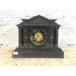 A Victorian slate mantle clock of architectural form, the arched pediment over frieze with Romo-