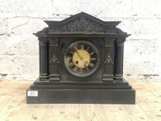 A Victorian slate mantle clock of architectural form, the arched pediment over frieze with Romo-