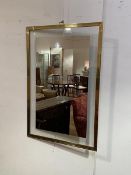 A brass rectangular framed wall mirror with glazed panel with mirrored section (92cm x 61cm)