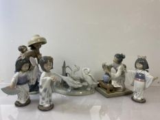 A group of Lladro figures including Lady in a Hat with Child (27cm), a Japanese lady arranging