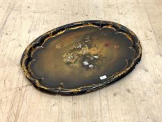 A large Victorian papier mache tray, the scalloped edge with scrolled gilt border framing a floral