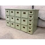 An late 19th century green painted hardwood haberdashers shop fitting, fitted with twelve drawers