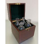 A 1920s mahogany decanter box retailed by Hamilton & Inches, Edinburgh containing three crystal