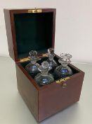 A 1920s mahogany decanter box retailed by Hamilton & Inches, Edinburgh containing three crystal