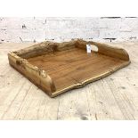 After Tim Stead, a naturalistic yew wood waney edge drinks tray, with pierced carry handle to each