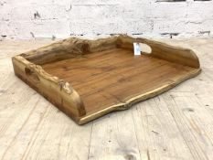 After Tim Stead, a naturalistic yew wood waney edge drinks tray, with pierced carry handle to each