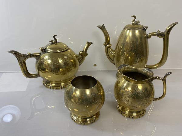 An Epns gilt tea and coffee service (coffee pot: 20cm), with swan finials, teapot, sugar bowl and