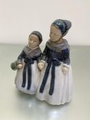 A Royal Copenhagen porcelain figure group, Two Young Girls in Traditional Costume