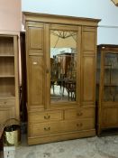 An Edwardian ash wardrobe, with mirrored door, fitted interior and three drawers to base, (No