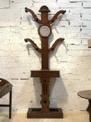 A Victorian mahogany hall stand, the shaped back with bevelled mirror and six hooks over a trinket