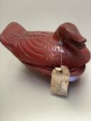 A Malaysian red lacquered treen duck highlighted with gold with paper invoice (16cm x 27cm x 13cm)