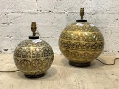 A graduated pair of Indian style Papier mache table lights, each decorated with foliate amongst