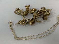 A gilt metal charm bracelet with collection of charms, most marked 9k, combined weight 47 grammes,