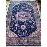 A Large Persian hand knotted carpet, the blue field decorated with geometric foliate framed within a