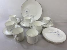 A Susie Cooper White Wedding pattern coffee set including four coffee cups and saucers, a cake plate