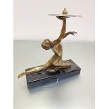 An Art Deco bronzed metal Dancing 1920s figure, with arm upraised, mounted on rectangular black