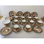 An early 20thc Royal Crown Derby Imari pattern teaset including ten cups, one with repairs (6cm),