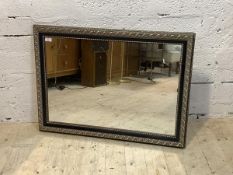 A silvered composition framed wall hanging mirror, 94cm x 68cm
