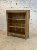 A contemporary light oak veneers open bookcase with two adjustable shelves, H110cm, W95cm, D31cm