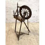 An early 20th century treadle spinning wheel with bobbin turned supports, H92cm