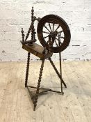 An early 20th century treadle spinning wheel with bobbin turned supports, H92cm