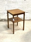 A Vintage mid century teak two tier table, the moulded top raised on square supports united by an