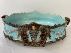 A 19thc Minton type centrepiece bowl with handles to sides and animals masks to either side, on