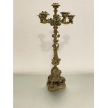 A 19thc cast brass five branch candelabra of Italian design, on triangular shaped tapered splay base