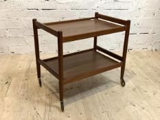 A mid century teak two tier drinks trolley, with turned supports and castors, H67cm, W72cm, D48cm