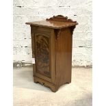 A Victorian walnut bedside cabinet, the ledge back over moulded top and panelled door enclosing a