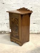 A Victorian walnut bedside cabinet, the ledge back over moulded top and panelled door enclosing a