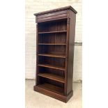 A mahogany floor standing open bookcase, the projecting cornice over drawer and five adjustable