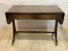 A Regency style mahogany sofa table, with two drop leaves, two drawers, raised on splayed supports