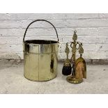 An early 20th century brass cylindrical log bucket with handle, together with brass four piece