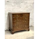 A Georgian style cross banded yew wood chest, fitted with two short adn three long graduated