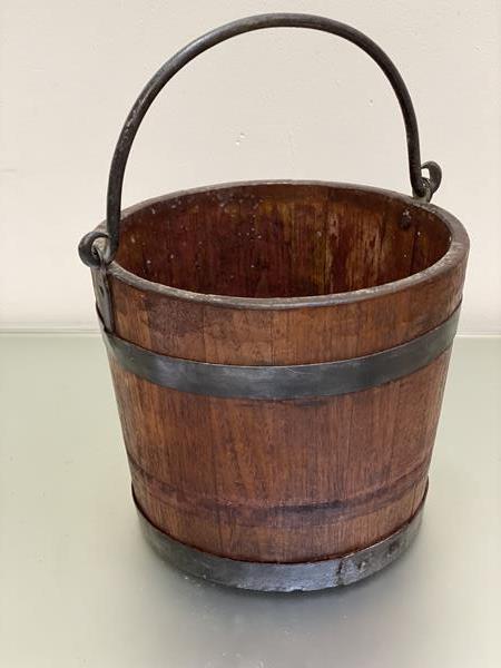 An oak iron bound coal bucket with cast iron swing handle to top (29cm x 33cm)