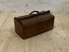 An early 20th century leather travelling case with old paper label, inscribed G to one end H34cm,