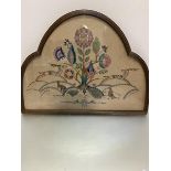 A 1920s/30s arched glazed oak framed and painted panel with sewn work Deer, Rabbits and Flowers,