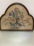 A 1920s/30s arched glazed oak framed and painted panel with sewn work Deer, Rabbits and Flowers,