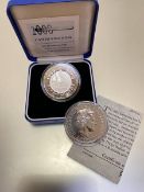 A 2001 fine silver (ounce) Britannia and a UK 925 silver proof 2000 Millenium £5 coin, boxed