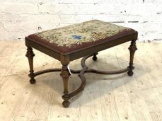 A Queen anne style walnut footstool, the needlework upholstered top over turned supports united by a