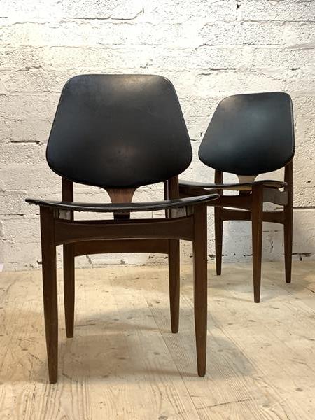 A pair of mid century teak dining chairs with vinyl upholstered seat and back, H80cm