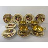 A matched Aynsley Orchard Gold teaset including tea cups with scalloped edges and another larger (