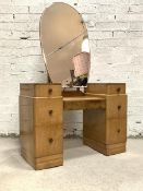 An Art Deco period bird eye maple twin pedestal dressing chest, the large bevelled swing mirror of