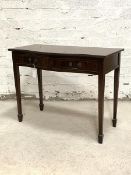 A Regency style mahogany serpentine side table, the cross banded top with reeded edge over two