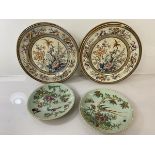A pair of Chinese plates, each depicting exotic birds on flowering branch with butterflies, both