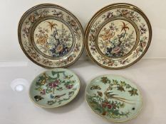 A pair of Chinese plates, each depicting exotic birds on flowering branch with butterflies, both