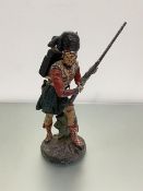 A cast iron doorstop style figure of a Scots Highlander, painted with polychrome enamels (sword a/f)