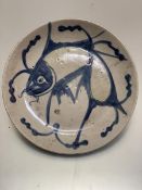 A Chinese Quing Dynasty dish decorated with carp, signed to front in underglaze blue (d.23cm)